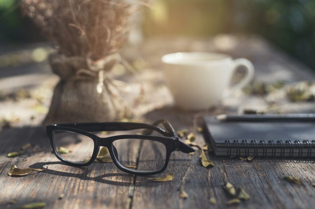 Notebook with cup of coffee and cellphone